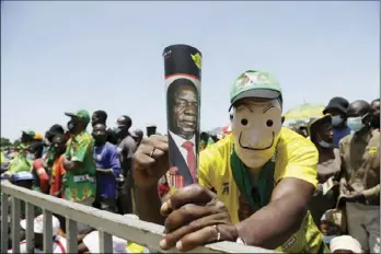  ?? ?? A man hides his face in the mask while attending a Zanu PF rally in Epworth yesterday. Hundreds of people attended the rally violating guidelines for Covid-19. Picture: Aaron Ufumeli