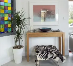  ??  ?? Above left: A detail of the sitting room — the zebra-print stool cover is a touch of fun