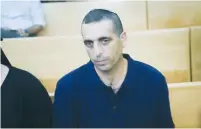  ?? (Flash90) ?? FORMER BRIG.-GEN. Ofek Buchris sits in Jaffa military court yesterday at the start of his trial on counts of rape and other sexual crimes.