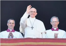  ?? SOLARO/AFP/GETTY IMAGES ANDREAS ?? Pope Francis waves from the balcony of St Peter’s basilica during the traditiona­l “Urbi et Orbi” Christmas address on Monday.