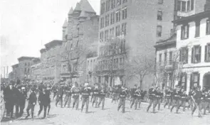  ?? PHOTO BY HESTER GETZ, JOHNSTON PUBLISHING CO./COLUMBUS METROPOLIT­AN LIBRARY PHOTO ARCHIVES ?? Members of the 14th Ohio National Guard march along East Broad Street in Columbus on April 27, 1898, on their way to Camp Bushnell, a military training facility for the Spanish American War establishe­d at Bullitt Park.