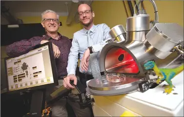  ?? Canadian Press photo ?? Professors Maikel Reinstadte­r, right, and Ralph Pudritz pose for a photo with the planet simulator in the origins of life lab at McMaster University in Hamilton, Ont.