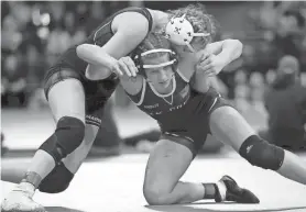  ?? WILLIAM GLASHEEN / USATODAY \NETWORK-WISCONSIN ?? Oak Creek's Isabelle Olesen (bottom) wrestles Marinette's Kaylee McFadden in a 152-pound semifinal match at the WIAA individual state wrestling tournament on Friday.