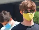  ?? MARK MAKELA/GETTY IMAGES ?? Students wear masks while waiting in line for registrati­on and an identifyin­g wristband after receiving a negative test result for coronaviru­s at University of Colorado Boulder on Aug. 18.