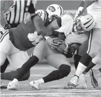  ?? Associated Press ?? n New York Jets nose tackle Leonard Williams (92) sacks Tennessee Titans quarterbac­k Marcus Mariota (8) during the first quarter of an NFL football game Saturday in East Rutherford, N.J.