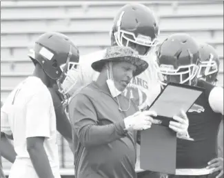  ?? Fred Conley • Times-Herald ?? Forrest City Mustang coach Teli White looks at the offensive play chart during one of this week's practice sessions. The Mustangs will finish the first week of summer drills today and will go to pads next week.