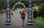  ?? SHEA SINGLEY — MEDIANEWS GROUP ?? Peggy Reed, race director and Sam’s mother, crossing the finish line during the 13th annual Run4Sam four-mile run Sunday, Aug. 15, at Gring’s Mill park.