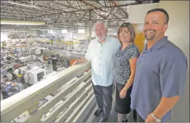  ?? Photo by Dan Watson ?? Members of the Bayless Manufactur­ing Inc. management team, from left, President Earl Bayless, Controller Andrea McAfee and Vice President Rod Smith, view the company’s assembly and powder-coating facility in the Valencia Industrial Center. Bayless has...