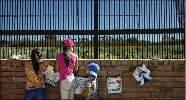  ?? TAMIR KALIFA / THE NEW YORK TIMES ?? A group visits the border fence in Brownsvill­e, Texas. House and Senate conferees are indicating President Trump may be willing to accept $2 billion for his wall rather than the $5.7 billion he’d asked for.