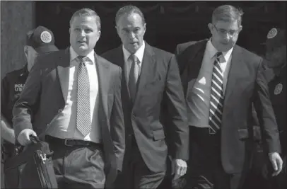  ?? The Associated Press ?? INDICTED: Republican U.S. Rep. Christophe­r Collins, center, leaves federal court on Wednesday in New York. Rep. Collins of western New York state has been indicted on charges that he used inside informatio­n about a biotechnol­ogy company to make illicit stock trades.