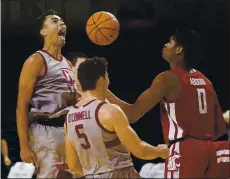  ?? JEFF CHIU — THE ASSOCIATED PRESS ?? Stanford’s Oscar da Silva, left, who had 27 points and 13 rebounds in a victory Saturday over Washington State, celebrates with Michael O’Connell after scoring and being fouled while the Cougars’ Efe Abogidi watches.