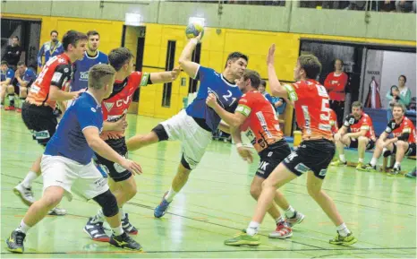  ?? FOTO: MARKUS PEIKER ?? Stefan Hörcher von der HSG Rietheim-Weilheim (blaues Trikot) kann sich hier gegen Rottweils Abwehr nicht durchsetze­n.