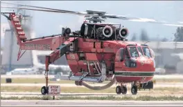  ?? Austin Dave/The Signal ?? The Erickson S-64 Air Crane taxis the runway at Van Nuys Airport as it heads to the tanker base on Sunday.