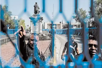  ?? PEDRO PARDO/GETTY-AFP ?? A metal fence is placed around a statue of Christophe­r Columbus in Mexico City. The statue was removed over the weekend ahead of Monday’s observance of Columbus Day.