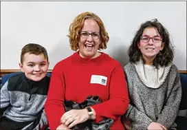  ?? TY TAGAMI / TTAGAMI@AJC.COM ?? Jennifer Moore, here with her two children, said Georgia Cyber Academy has allowed her son and daughter stability through home moves; she said that at home she can also help them when needed.