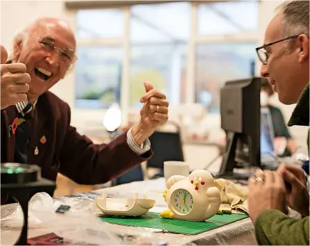  ?? ?? Bath Share and Repair volunteers restore an alarm clock to full working order