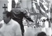  ?? THE ASSOCIATED PRESS ?? A pallbearer lays a rose next to a photo of Jack Beaton during his memorial service at St. Elizabeth Ann Seton Catholic Church in Bakersfiel­d, Calif., on Saturday. Beaton was a victim of the Oct. 1 mass shooting in Las Vegas.