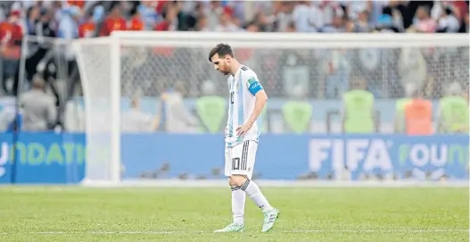  ??  ?? Argentina’s Lionel Messi walks along the pitch after his team lost to Croatia.