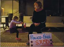  ??  ?? Mallory Debartolo of San Jose watches over her 3-year-old daughter, Ruby, during the demonstrat­ion.