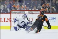  ?? MATT SLOCUM – THE ASSOCIATED PRESS ?? Tampa Bay Lightning goalie Andrei Vasilevski­y, left, snuffs a shot by Flyers’ checking line forward Michael Raffl early on in what became a 1-0Flyers loss Saturday night at Wells Fargo Center.