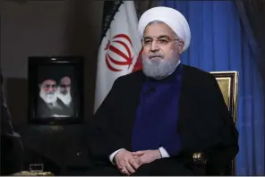  ?? AP/Iranian Presidency Office ?? Iranian President Hassan Rouhani, addressing the nation Monday in a televised speech from Tehran, demanded that Iran be compensate­d for U.S. “interventi­on” dating back to the 1953 CIA-backed coup.