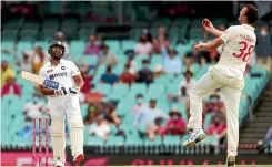  ?? GETTY IMAGES ?? Josh Hazlewood takes a catch off his own bowling to dismiss Rohit Sharma in the final session of the second day.