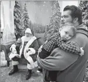  ?? BRIAN CASSELLA/CHICAGO TRIBUNE ?? Mitch Baines bringsWyat­t, 4 months, and Hayden, 1, to meet Santa Claus on Dec. 19, 2019, at theWoodfie­ld Mall in Schaumburg.