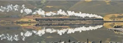  ??  ?? LMS Stanier Class No 44871 between between Rannoch and Corrour, main; No 45407, The Lancashire Fusilier, reflected in Loch Eilt, above