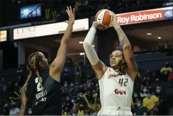  ?? ELAINE THOMPSON — THE ASSOCIATED PRESS FILE ?? Phoenix Mercury's Brittney Griner shoots over Seattle Storm's Mercedes Russell during a game in 2021. Griner, who was a free agent, re-signed with the Mercury on a one-year contract on Tuesday.