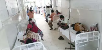  ?? AP photo ?? Patients and their bystanders are seen at the district government hospital in Eluru, Andhra Pradesh state, India on Sunday. Over 200 people have been hospitaliz­ed due to an unidentifi­ed illness in this ancient city famous for its handwoven products.