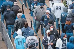  ?? JOHN MINCHILLO/AP PHOTO ?? Spectators wait in a security line outside Yankee Stadium before an opening day baseball game against the Toronto Blue Jays on Thursday in New York.