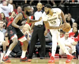  ?? ERIK WILLIAMS-USA TODAY SPORTS ?? NEW ORLEANS PELICANS’ forward/center Anthony Davis (23) handles the ball while Houston Rockets’ guard James Harden defends during their season opener match’s third quarter at Toyota Center.