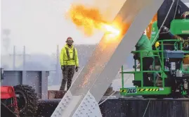  ?? KAITLIN NEWMAN/MEMBER, ASSOCIATED PRESS ?? Workers are seen in the beginning stages of dismantlin­g the steel from the frame of the collapsed Francis Scott Key Bridge, using an exothermic cutting torch, April 4, in Baltimore.