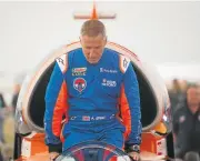  ??  ?? Pilot Andy Green climbs into the cockpit of the car.