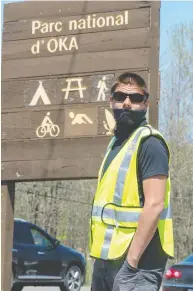  ?? RYAN REMIORZ / THE CANADIAN PRESS FILES ?? Mohawks from Kanasatake block the entrance to Oka provincial park last week in Quebec. The Mohawks fear the partial reopening of the park will increase
the risk of COVID-19 in the area.