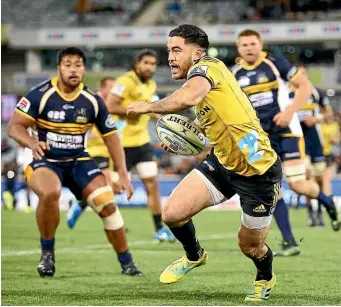  ?? GETTY IMAGES ?? Nehe Milner-Skudder playing for the Hurricanes takes on the Brumbies defence during a Super Rugby match.