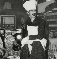  ??  ?? ZAPPA CUTS A SNAKE CAKE OUTSIDE A NEW YORK CINEMA WHERE BABY SNAKES WAS PREMIERING. THE 20-FOOT CAKE, SERVED TO PASSERS-BY FROM A FLATBED TRUCK, WAS TO MARK ZAPPA’S 39TH BIRTHDAY.