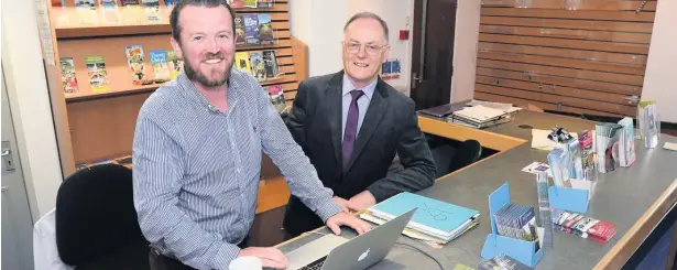  ??  ?? ● Caernarfon Informatio­n Centre. Gavin Owen manager of Hwb Caernarfon and Cllr Edgar Wyn Owen chairman in the centre