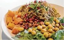  ??  ?? Kerala Noodle Salad features buckwheat noodles tossed with garbanzo beans, pickled carrots, spinach, lime and peanuts.