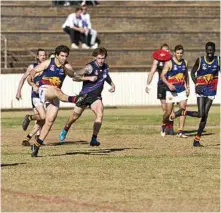  ?? Photo: Kevin Farmer ?? TOP SPOT: Ashley Harley kicks downfield for the USQ Cougars in their win over South Toowoomba.