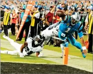  ?? MIKE MCCARN ?? Carolina Panthers’ Cam Newton (1) dives for the end zone as Philadelph­ia Eagles’ Patrick Robinson (21) and Rodney Mcleod (23) defend in the second half of an NFL football game in Charlotte, N.C., Thursday. Newton was ruled down before the goal line.