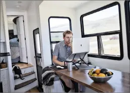  ?? PICTURE: WASHINGTON POST ?? Kevin Holesh works in the mobile home where he and his wife live full time as they travel the US. An app he created helps people pull away from constant social media use.