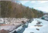  ?? TANIA BARRICKLO — DAILY FREEMAN FILE ?? Muddy water from the Ashokan Reservoir flows through the Little Beaverkill in the town of Olive in December 2010 en route to the Lower Esopus Creek. At the right side of the photo is state Route 28A.