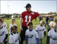 ?? MATT DUNHAM — THE ASSOCIATED PRESS ?? Philadelph­ia Eagles’ quarterbac­k Carson Wentz joins in with an NFL Flag event for local school children at an NFL training session at the London Irish rugby team training ground in the Sunbury-on-Thames suburb of south west London earlier this week. Wentz and the Eagles will face the Jacksonvil­le Jaguars at Wembley Stadium in London today.
