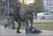  ?? THE ASSOCIATED PRESS ?? Police officers kick a demonstrat­or during a mass protest following the presidenti­al election in Minsk, Belarus, Monday.