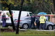  ?? (AP/Houston Chronicle/Melissa Phillip) ?? Police investigat­e Friday at the scene of a deadly shooting in
Houston.