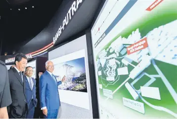  ??  ?? Najib looks at displays during the unveiling of KL-Singapore HSR station concept designs yesterday. Also present are Menteri Besar Negeri Sembilan Datuk Seri Mohamad Hasan (left) and Melaka Chief Minister Datuk Seri Idris Haron (second left). — Bernama...