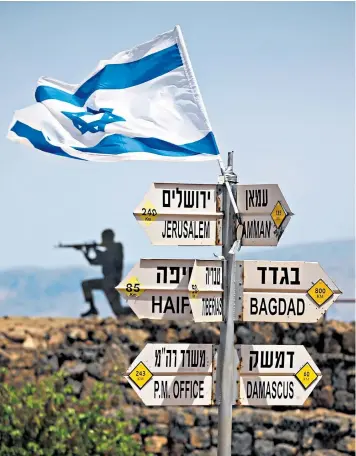  ??  ?? An Israeli soldier on guard at the Golan Heights, above, amid heightened tension after rockets were fired from Damascus, Syria, top left. Israel blamed the attacks on Iran, a claim neither confirmed nor denied by Tehran