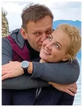  ?? ?? Putin’s victim: Flowers left at a memorial to Alexei Navalny after his death, with his wife Yulia before his courageous return to Russia, and defiantly cheerful in the Polar Wolf penal colony