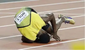  ??  ?? Bolt tumbled to the ground as he was passed by the other athletes on a night where his fairy-tale ending didn’t materialis­e